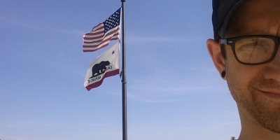 In front of flagpole in California