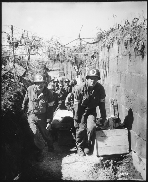 WWII Medics remove a casualty from the battlefield